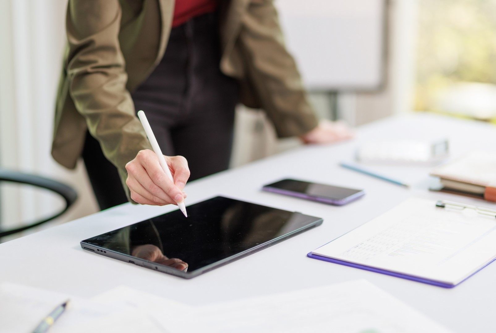 Advisor working on a tablet with a stylus