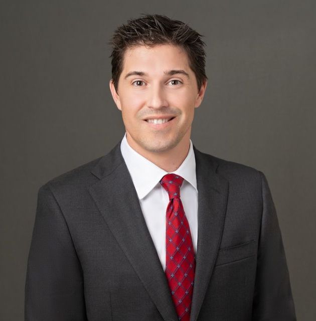 Don Henderson wearing a suit and tie